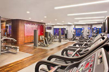 State of the art fitness center with exercise machines and machine-specific TVs