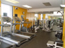 Fitness center with exercise machines and floor-to-ceiling mirrors