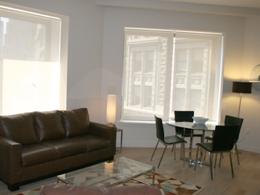 Temporary apartments at 75 Wall Street: open living/ dining area with oak floors