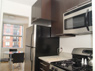 Kitchen and dining area with porcelain tile floors, granite countertops, Eurostyle cabinets and GE appliances